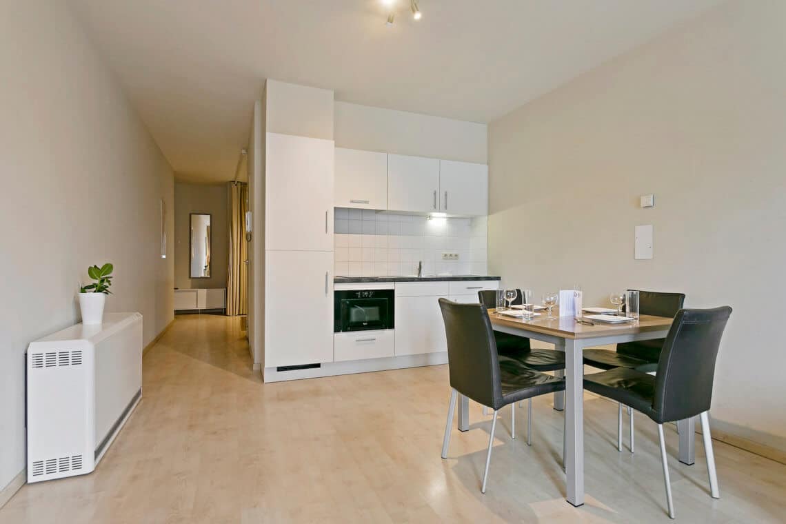 fully equipped kitchen and four person dining table