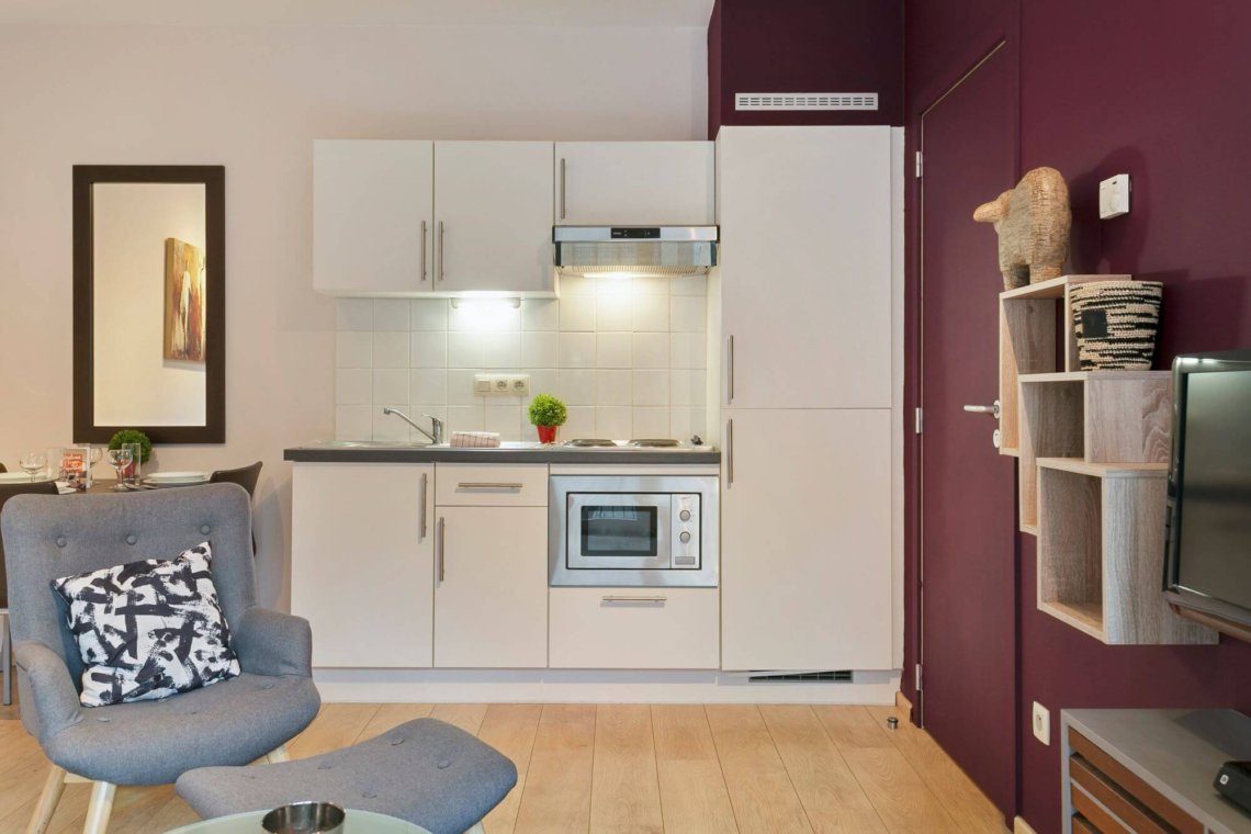 living room of serviced studio apartment with fully equipped kitchen