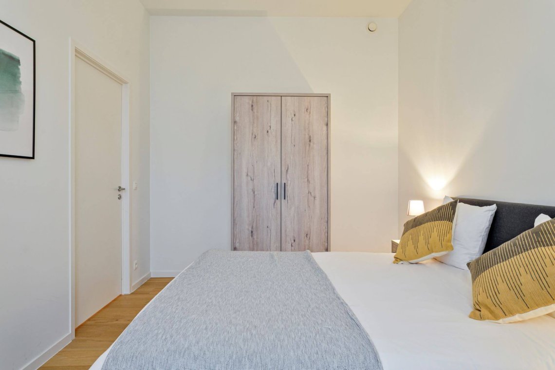 spacious bedroom with wardrobe storage in bbf serviced apartment antwerp