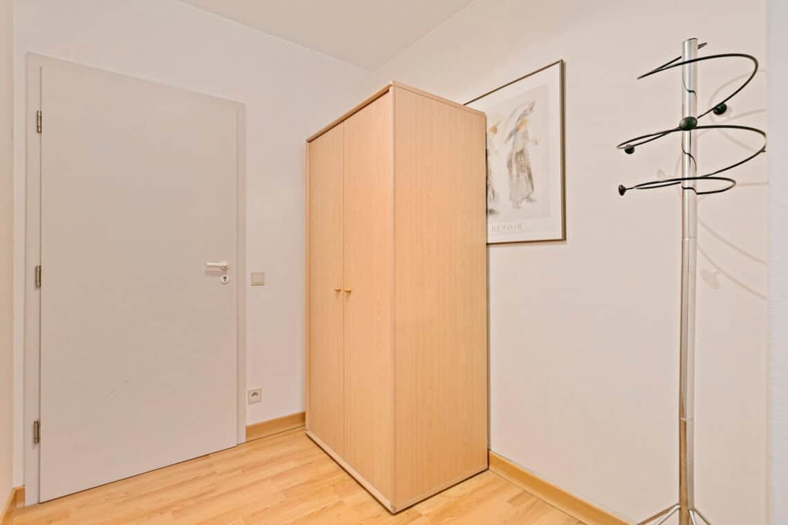 entrance to studio apartment with storage cupboard