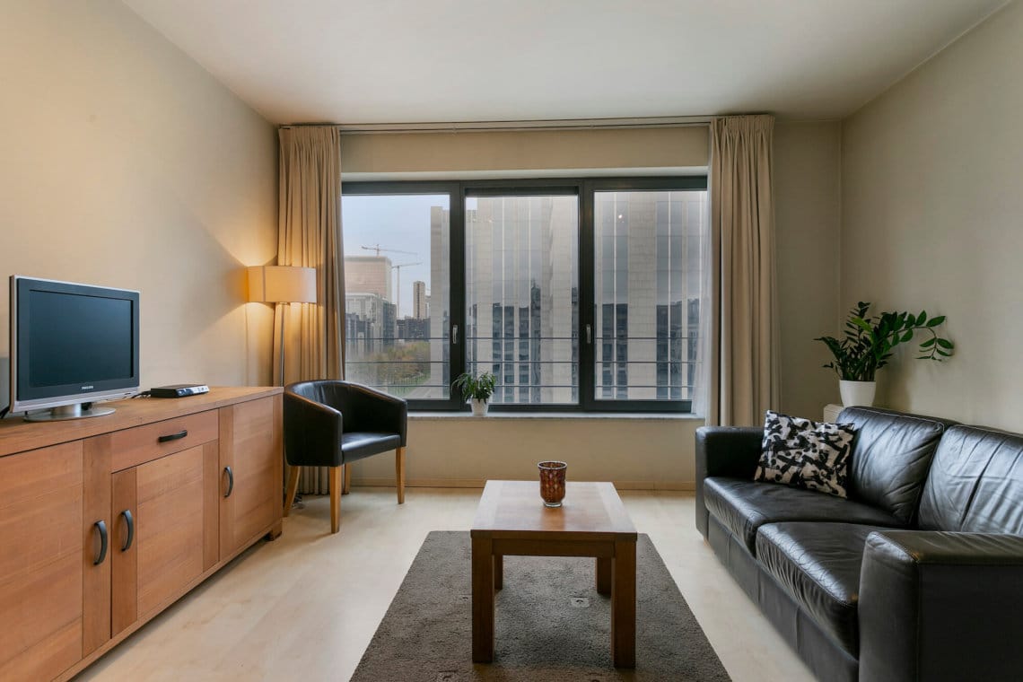 spacious living room in studio apartment near brussels world trade centre