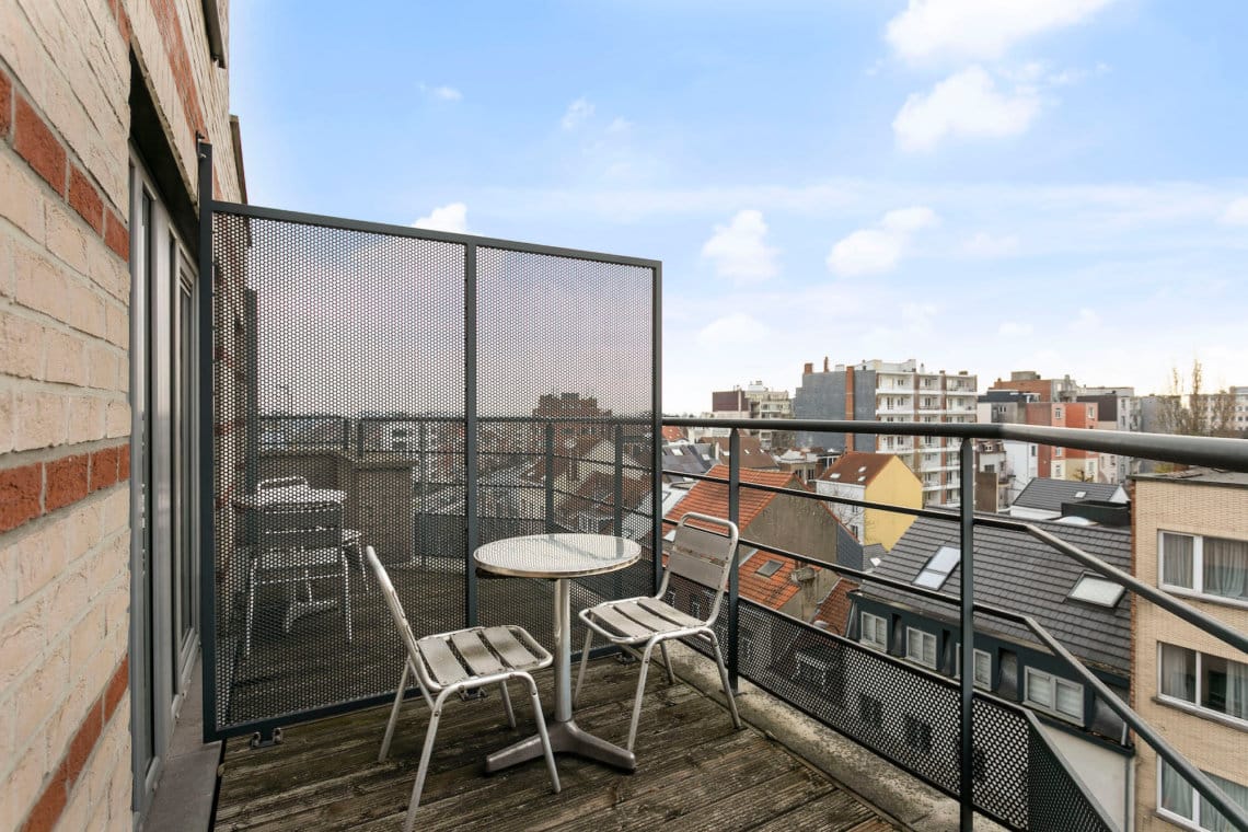 outdoor balcony with table and chairs in serviced apartment