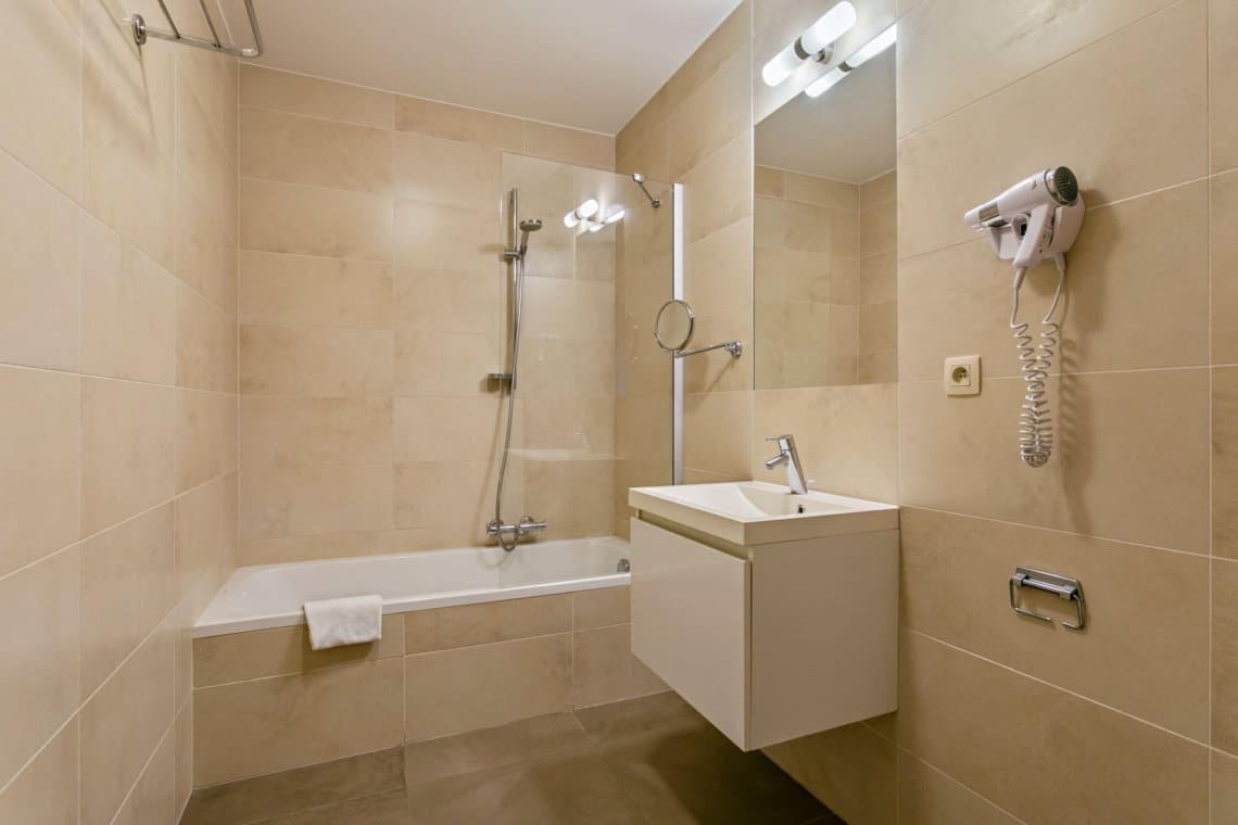 bathroom with bathtub and shower in stephanie louise brussels