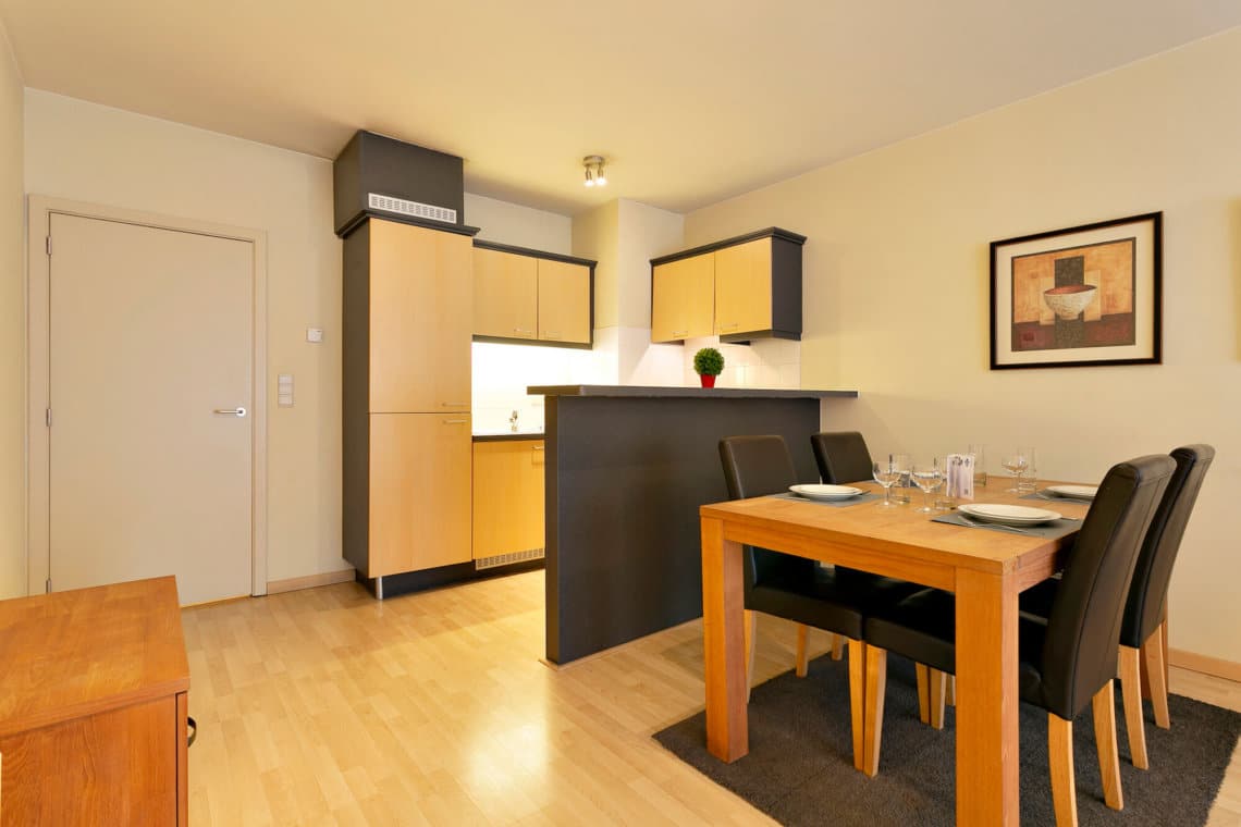 fully equipped kitchen with dining tablein bbf serviced apartment in etterbeek near place jourdan