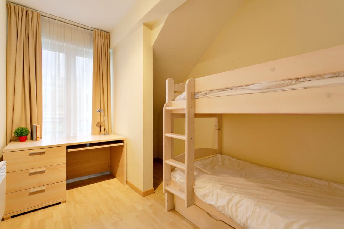 second bedroom with bunk beds and office desk for home working in jourdan residence