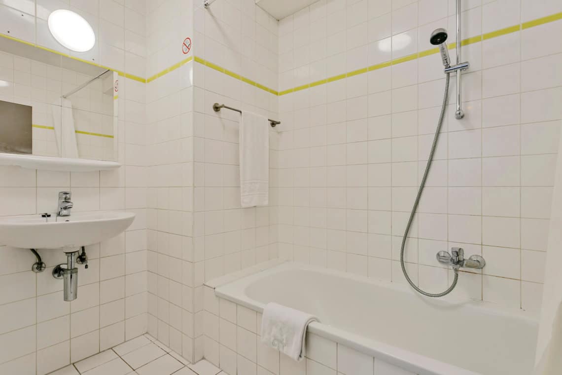 bathroom with bathtub in bbf furnished apartment in brussels