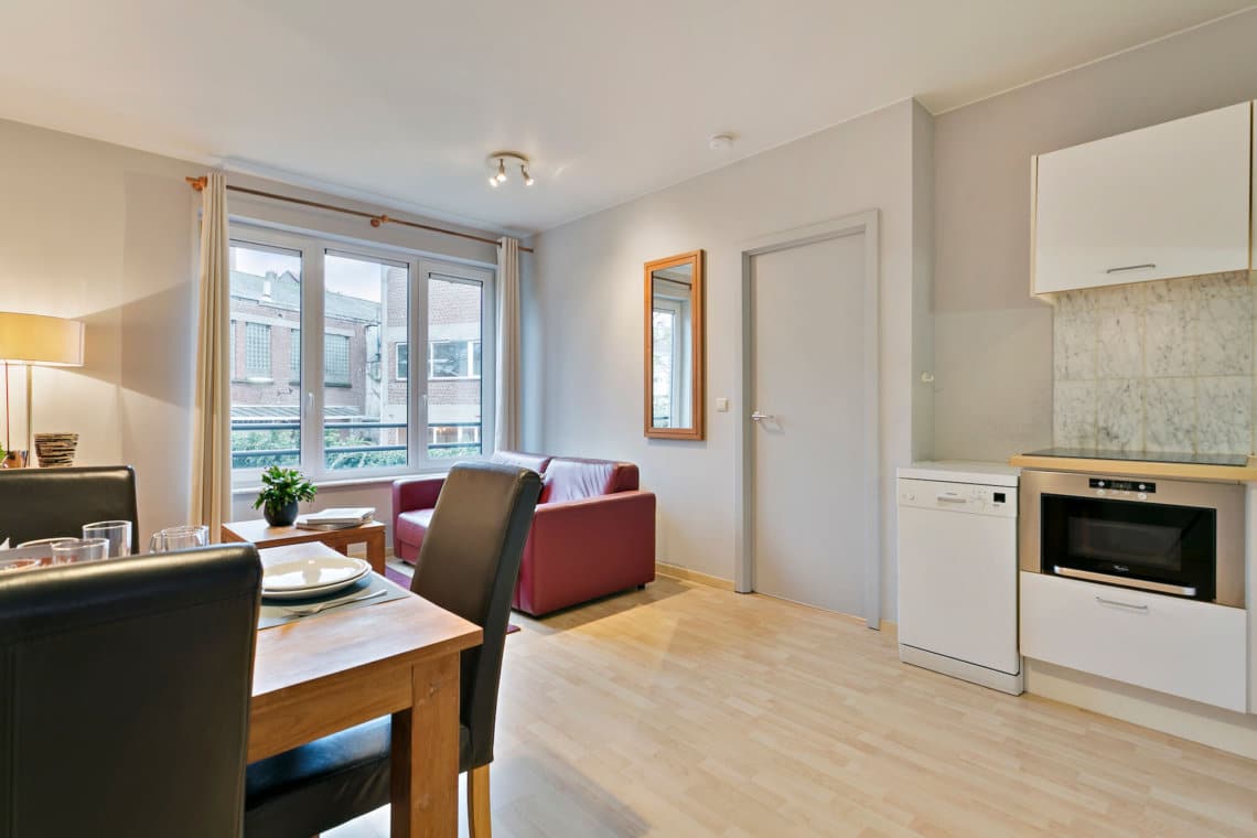 living room with sofa and dining table in spacious one bedroom apartment