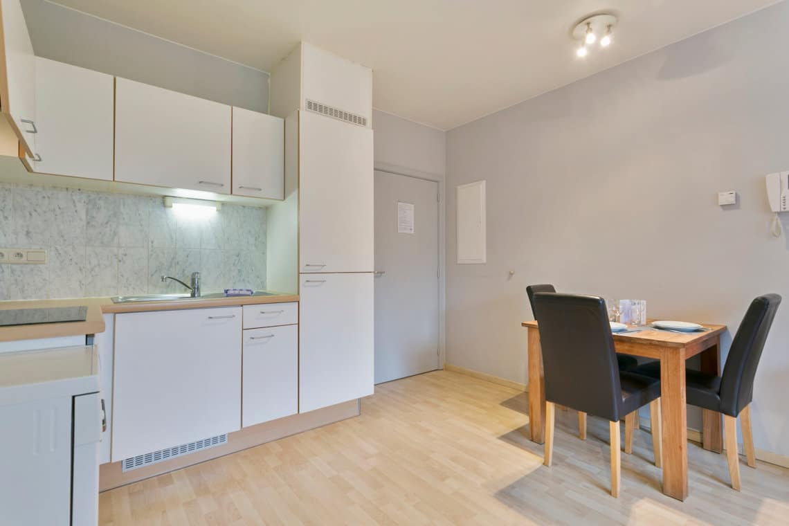 fully equipped kitchen with utensils and dining table near famous place jourdan in etterbeek brussels