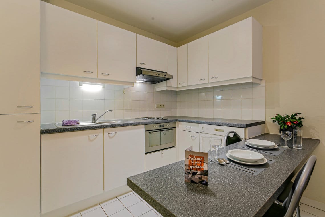 fully equipped kitchen with microwave in bbf serviced apartment woluwe