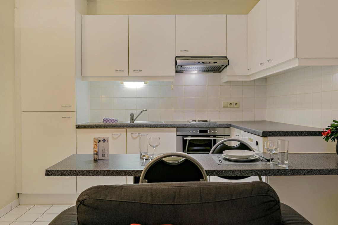 fully equipped kitchen and dining in serviced apartment brussels