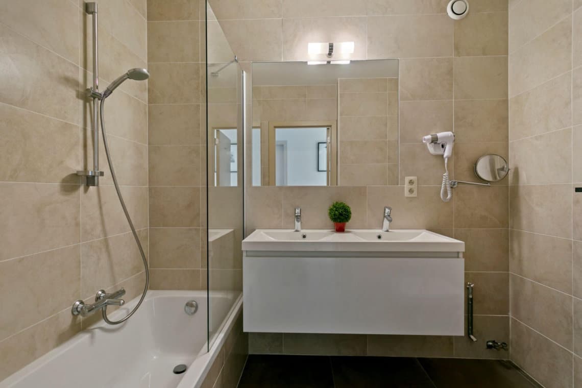 bathroom with double sink, shower and bath in bbf serviced apartment