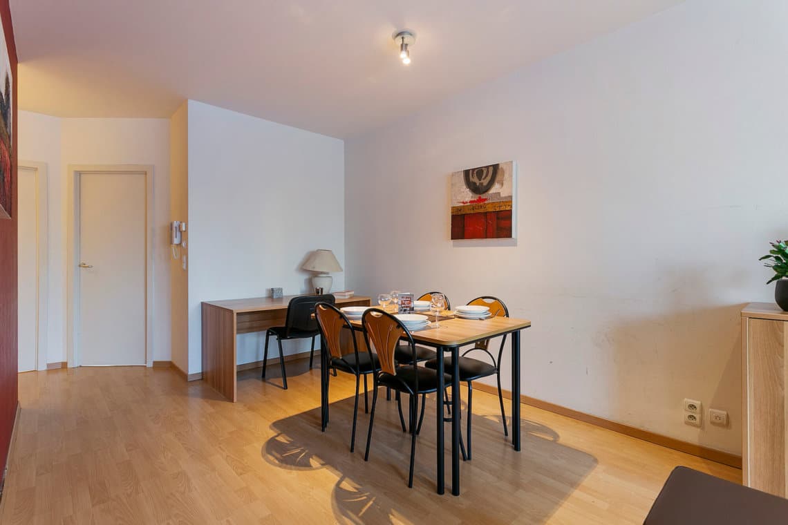 living space and office desk next to european commission in two bedroom furnished apartment