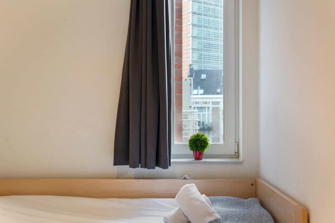 single bed in second bedroom with views onto the european commission