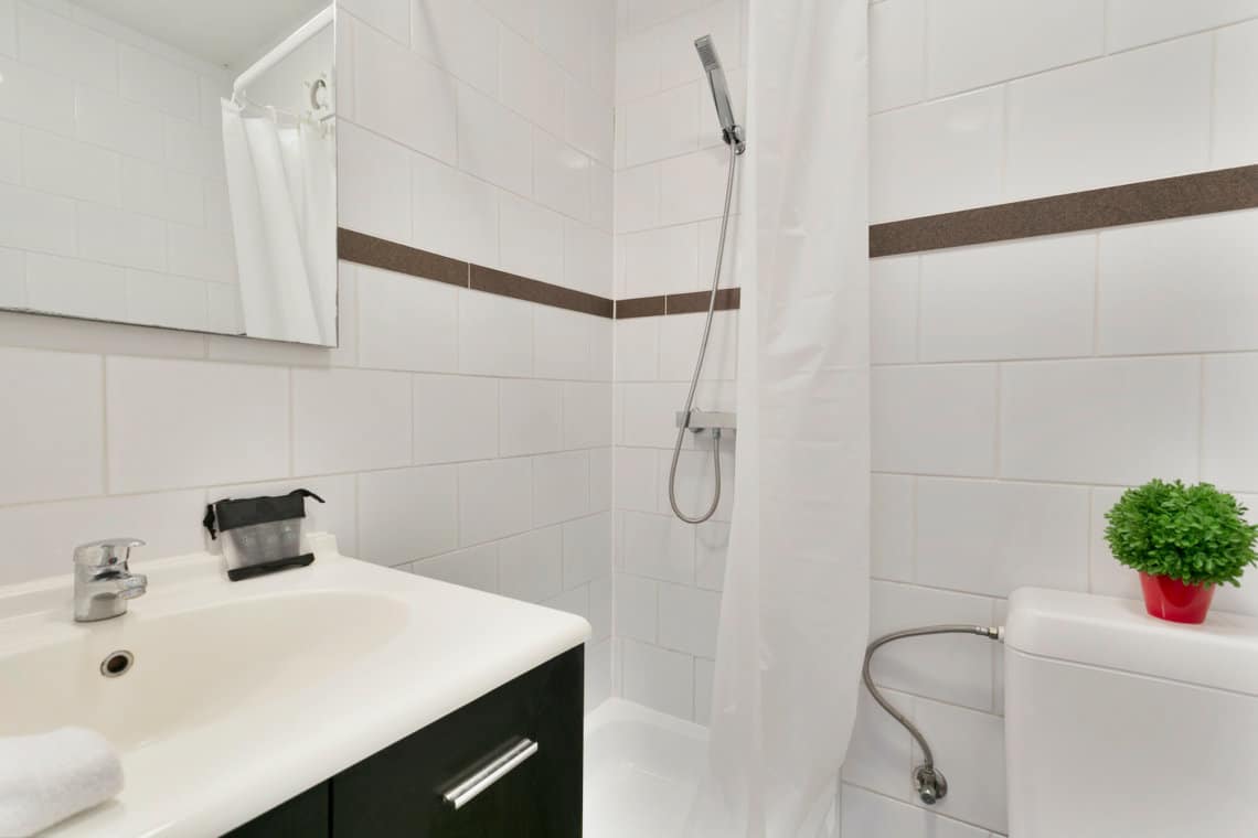 serviced studio bathroom with shower with cleaning and towels