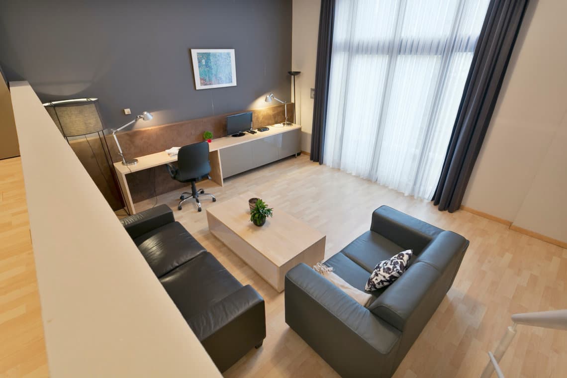 view over living room and office space in two bedroom furnished apartment near european commission