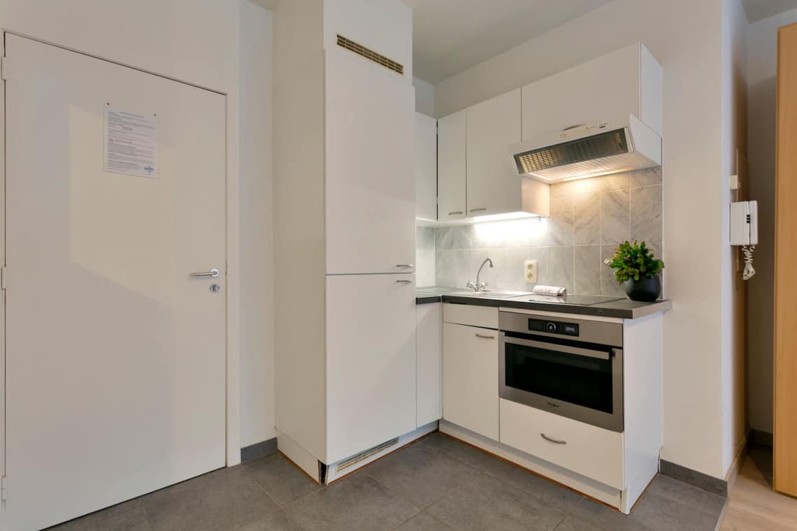 fully equipped kitchen in studio apartment opposite cinquantenaire