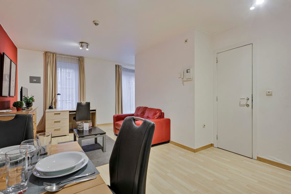 dining table and living space in serviced apartment near european commission