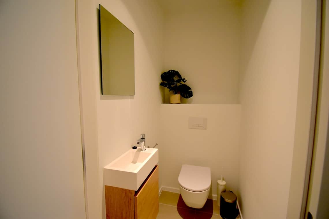 A clean and modern toilet in a furnished apartment